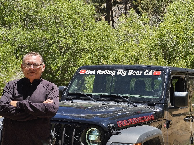 Eddie Davison standing beside the Get Rolling Jeep